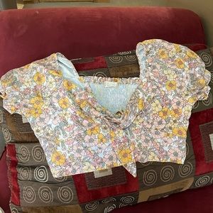 This is a summer crop top made of 100% polyester and was made by Altar’d state